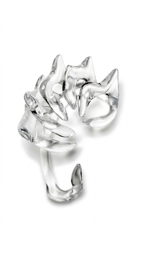 A transparent glossy sculptural jewelry piece: an ear cuff with curved, claw-like arms, photographed on a clean white background.